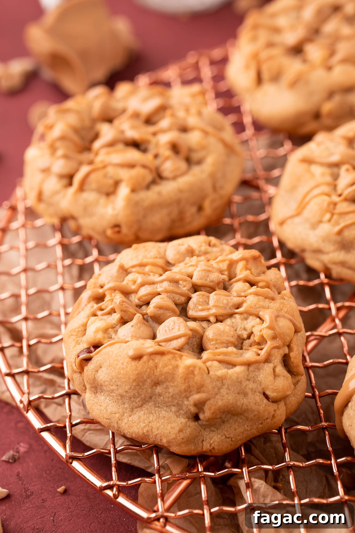 Thick Triple Peanut Butter Cookies on a copper wire rack.