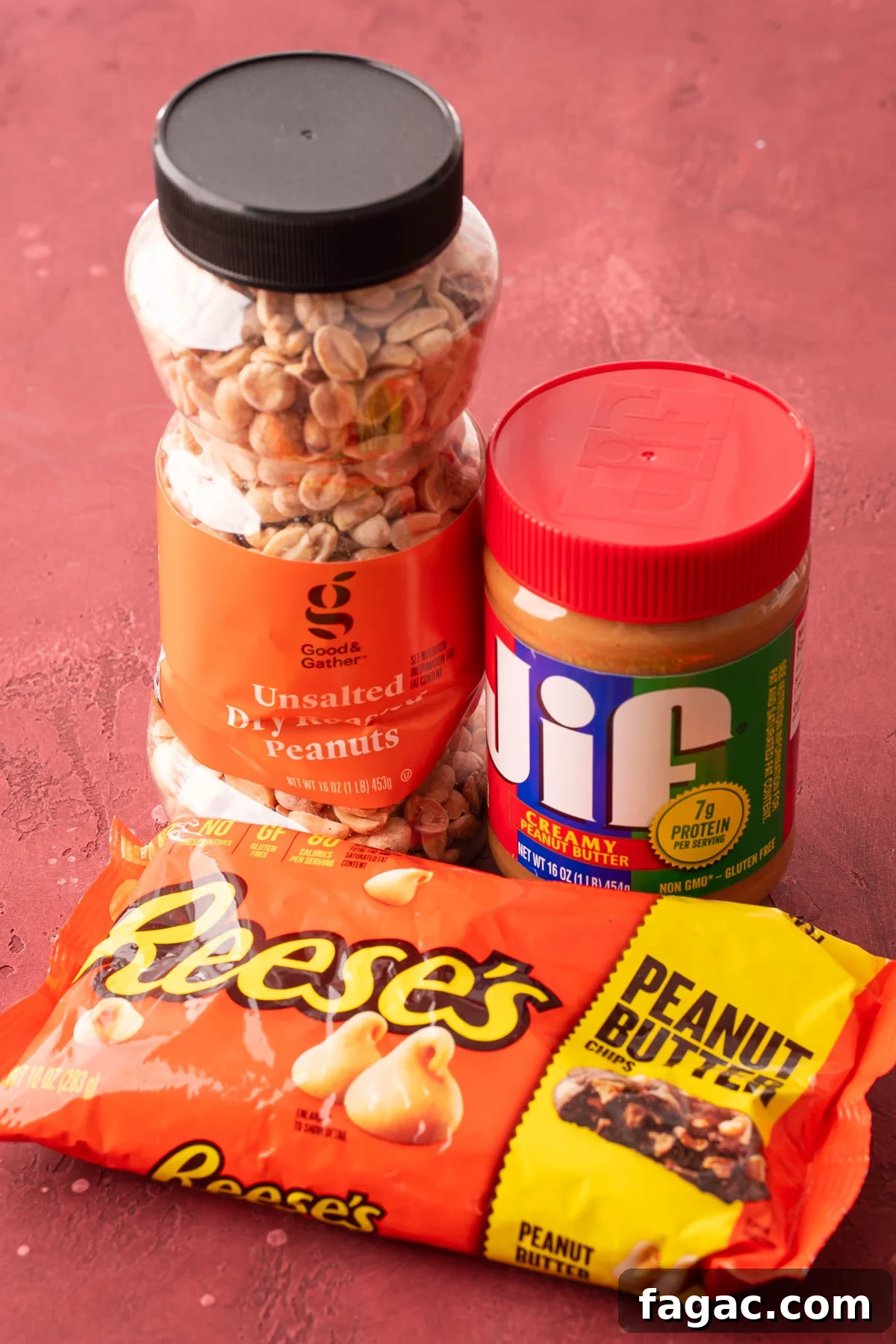 A container of peanuts, peanut butter, and a bag of peanut butter chips on a table.