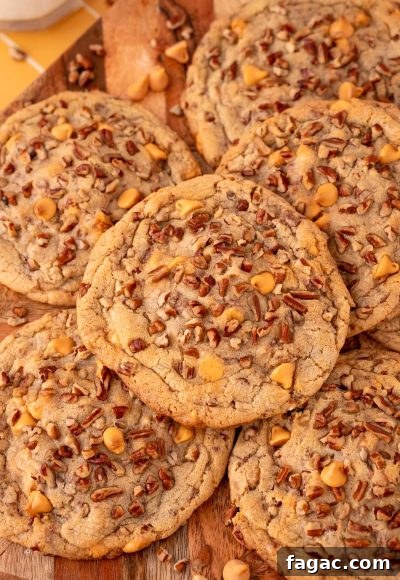 Overhead photo of butter pecan cookies on a wooden serving board.