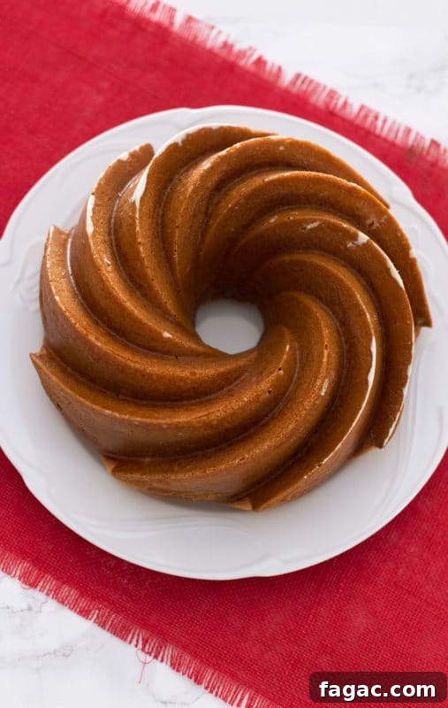 Orange Vanilla Bundt Cake sitting on a white plate.