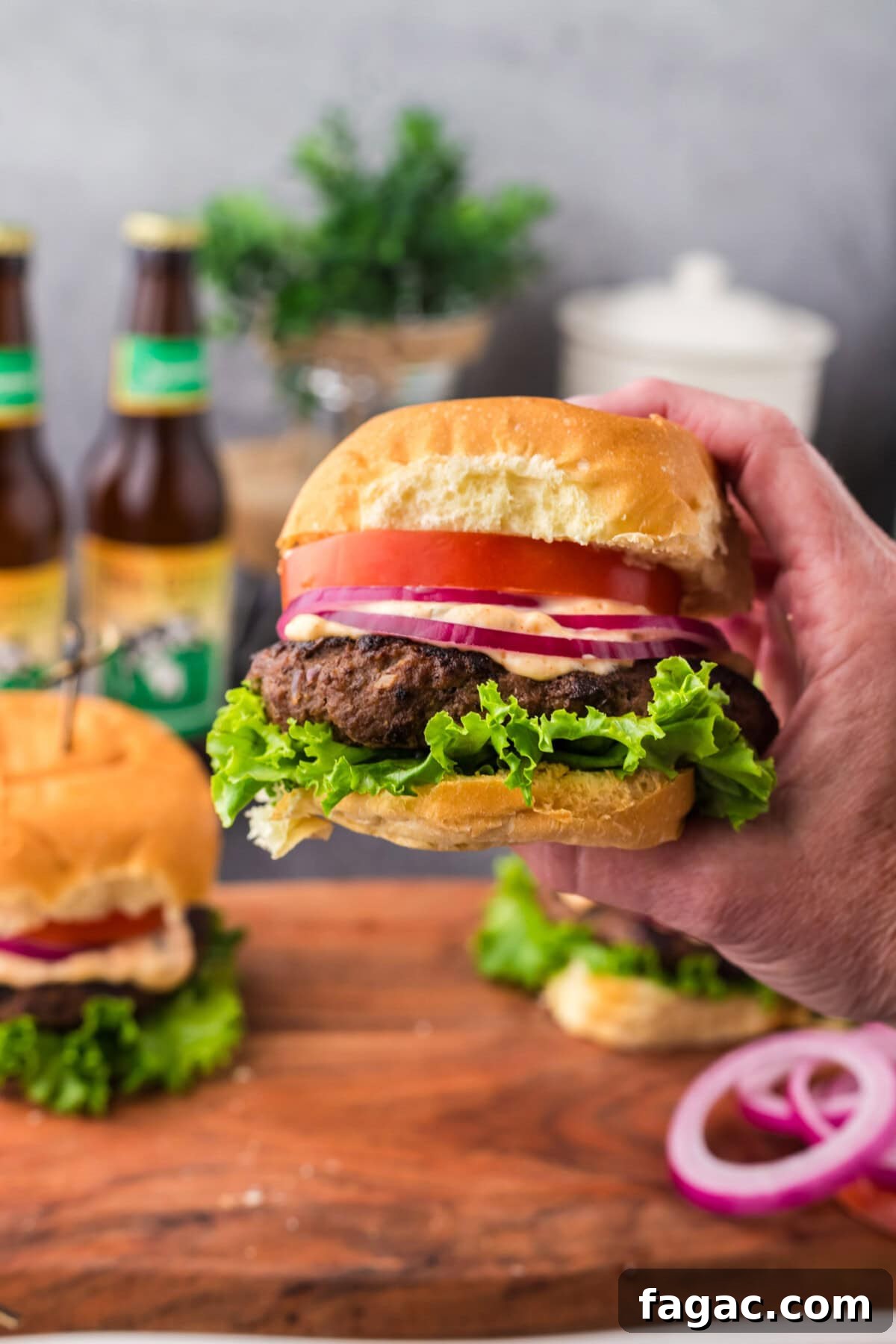 Buffalo Burger Recipe with Blue Cheese and Crispy Onions 12 Hand holding up a Buffalo Burger