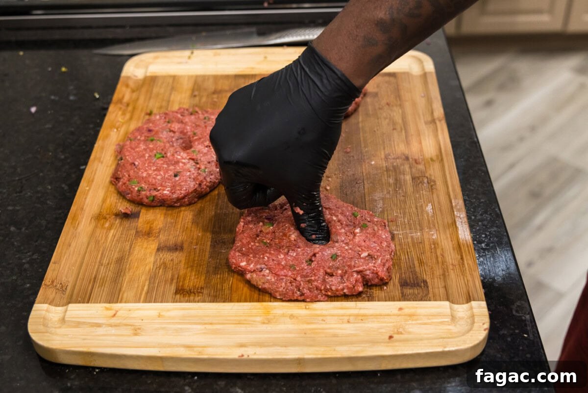 Buffalo Burger Recipe with Blue Cheese and Crispy Onions 9 pressing thumb into center of bison burgers