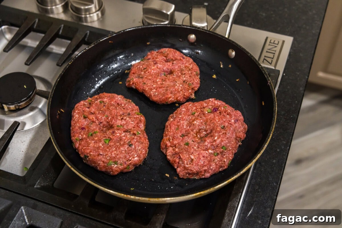 Buffalo Burger Recipe with Blue Cheese and Crispy Onions 10 cooking bison burgers in a skillet