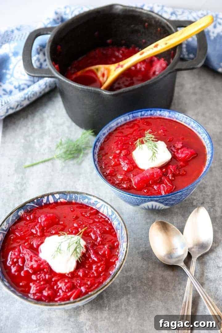 Authentic Ukrainian Borscht Recipe: Beet Soup 6 black pot and two blue and white bowls filled with Ukrainian borscht