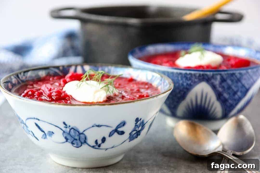 Authentic Ukrainian Borscht Recipe: Beet Soup 8 black pot and two blue and white bowls filled with Ukrainian borscht
