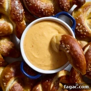 Creamy Beer Cheese Dip for Soft Pretzels 10 An overhead shot of Beer Cheese in a small bowl on a platter with soft pretzels.