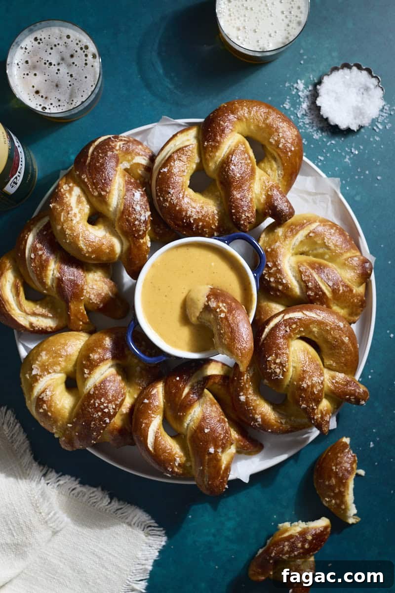 Creamy Beer Cheese Dip for Soft Pretzels 8 An overhead view of a platter of soft pretzels with a bowl of Beer Cheese in the middle.