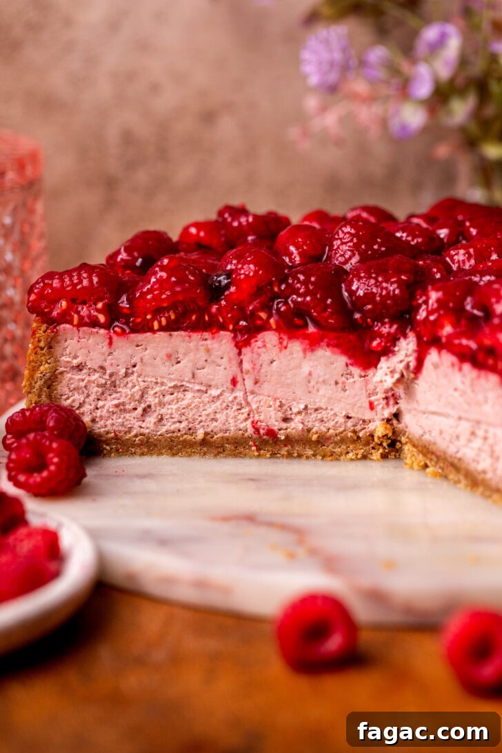 Decadent Raspberry Cheesecake Recipe 3 Side view of raspberry cheesecake.