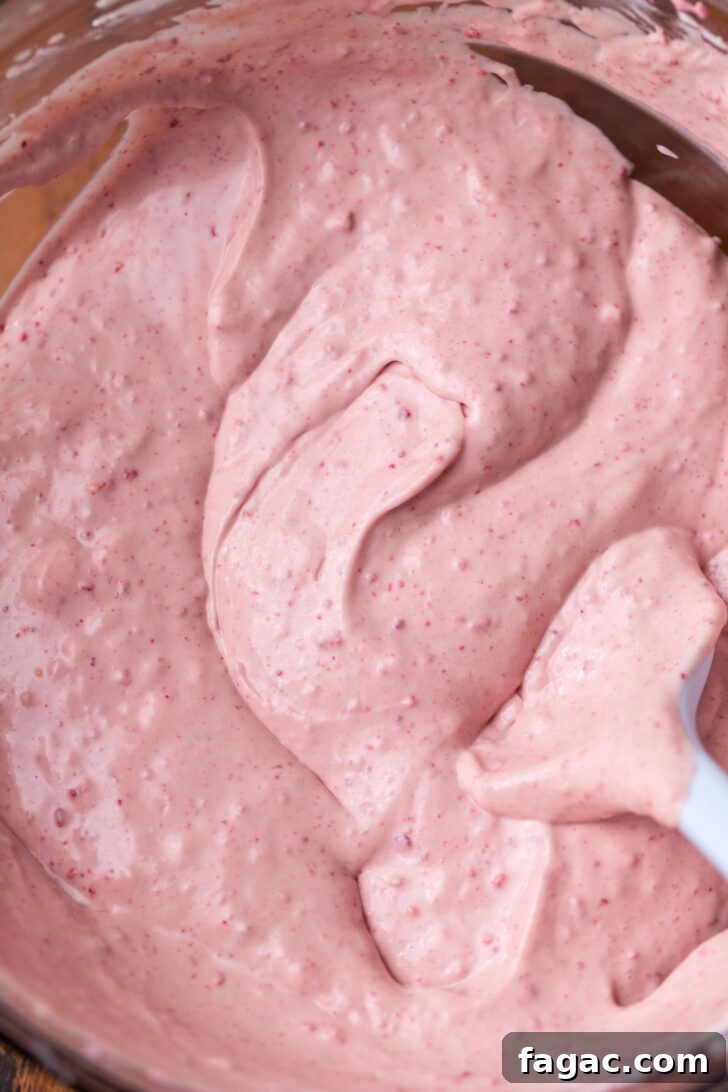 Decadent Raspberry Cheesecake Recipe 4 Raspberry cheesecake batter in a bowl.