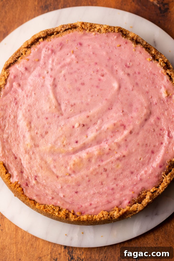 Decadent Raspberry Cheesecake Recipe 6 Baked cheesecake on a platter.