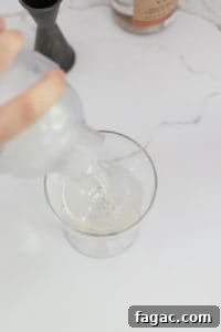 Dirty Martini Recipe: Tips for the Classic Cocktail 11 straining a martini.